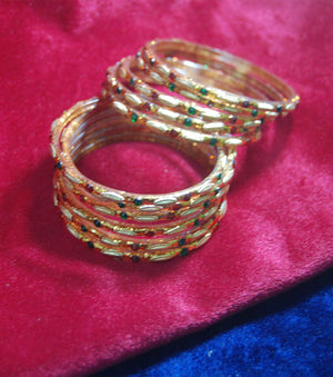 Golden glass bangles with glitters