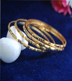 Gold plated bangles with work and lines set of 4