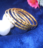 Gold plated bangles with work and lines set of 4