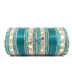 Light green colored metal bangle with zigzag golden work